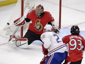Ottawa Senators goalie Craig Anderson makes a save as Montreal Canadiens' Dale Weise (22) and Senators' Mika Zibanejad (93) watch for a rebound during first period Stanley Cup NHL playoff hockey action in Ottawa on Wednesday, April 22, 2015.