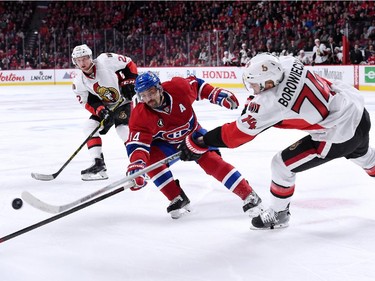 Mark Borowiecki #74 of the Ottawa Senators passes the puck in front of Tomas Plekanec #14 of the Montreal Canadiens during Game Five of the Eastern Conference Quarterfinals of the 2015 NHL Stanley Cup Playoffs at the Bell Centre on April 24, 2015 in Montreal, Quebec, Canada.