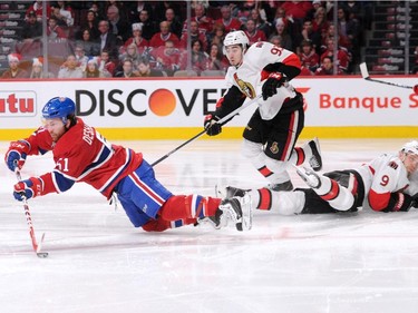 David Desharnais #51 of the Montreal Canadiens passes the puck while falling in front of Mika Zibanejad #93 and Milan Michalek #9 of the Ottawa Senators in Game Two of the Eastern Conference Quarterfinals during the 2015 NHL Stanley Cup Playoffs at the Bell Centre on April 17, 2015 in Montreal, Quebec, Canada.