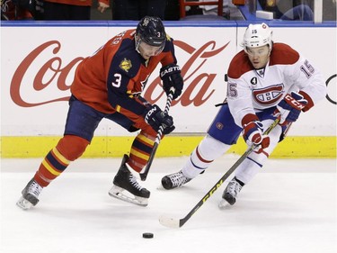 Canadiens' P.A. Parenteau  passes past Florida Panthers defenceman Steven Kampfer (3) during the third period of an NHL hockey game, Sunday, April 5, 2015, in Sunrise, Fla.