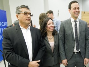 Parti Québécois leadership candidates Pierre Céré left,  Martine Ouellet and Alexandre Cloutier pose for photograph before the start of a leadership debate at the Université de Montréal on Jan. 28, 2015.