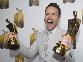 Éric Salvail holds up his awards for best variety show and talk show host at the annual Gala Artis awards ceremony in Montreal, Sunday, April 26, 2015.