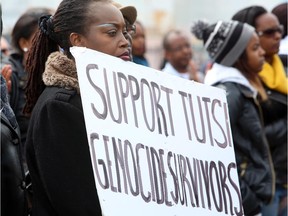 A woman takes part in a Rwandan genocide memorial rally on Parliament Hill, Monday April 7, 2014.