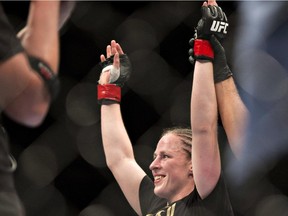 Sarah Kaufman, of Victoria, B.C., celebrates her victory to Leslie Smith, of Pleasant Hill, CA, Wednesday, April 16, 2014 at the UFC Fight Night in Quebec City.
