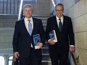 Prime Minister Stephen Harper and Finance Minister Joe Oliver walk together as he arrives to table the budget on Parliament Hill in Ottawa on Tuesday, April 21, 2015.