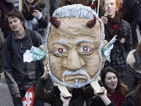 Students carry a mock head of Quebec Premier Philippe Couillard as they demonstrate against austerity measures and government cuts at a protest Thursday, April 2, 2015 in Montreal.