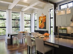 The ceiling in the kitchen is divided into huge squares by decorative beams which naturally guide the eyes to the tall windows.