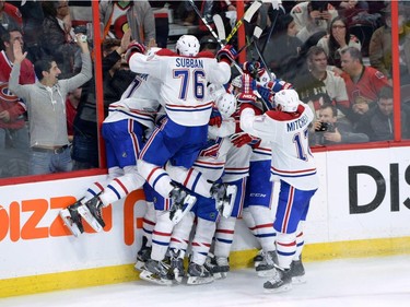The Montreal Canadiens celebrate their sudden death overtime win over the Ottawa Senators in game 3 of first round Stanley Cup NHL playoff hockey action in Ottawa on Sunday, April 19, 2015.