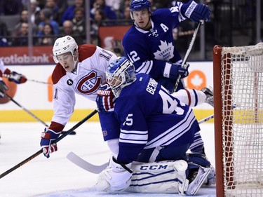 Toronto Maple Leafs goalie Jonathan Bernier looks for the puck as Montreal Canadiens' Brendan Gallagher(11) battles Maple Leafs' Tyler Bozak (42) in front of the net during first period NHL action in Toronto on Saturday, April 11, 2015.