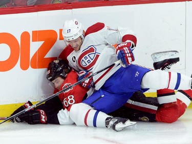 Montreal Canadiens forward Torrey Mitchell (17) hits Ottawa Senators forward Mike Hoffman (68) during the first period of game 3 of first round Stanley Cup NHL playoff hockey action in Ottawa on Sunday, April 19, 2015.
