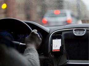 The Uber Technologies Inc. application runs on an Apple Inc. iPhone during an Uber ride in Washington, D.C., U.S., on Wednesday, April 8, 2015.