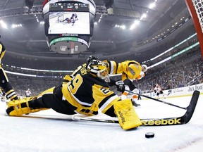 Penguins goalie Marc-André Fleury lets a puck get by him during a game against the Flyers on April 1. The Penguins played the game with only five defencemen because of injuries and salary cap limitations.