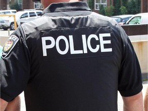 OTTAWA, ONT. -JUNE 1, 2010- Police Constable John Black and Tim Renwick escort a suspect following his arrest in a Community Housing Unit in Lowertown for being one of the 84 persons that the Ottawa Police Street Crime Unit has issued warrants for arrest following a three month long investigation, code named "Project Woody", into drug dealing on the streets of Ottawa. (Photo by Wayne Cuddington, The Ottawa Citizen.) Meghan Hurley story.  Assign#100117--Special Report: Ottawa's Dirty Little Secret: Crack Cocaine