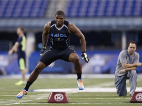 Defensive lineman Michael Sam takes part in position drills during the 2014 NFL Combine at Lucas Oil Stadium in Indianapolis on Feb. 24, 2014.