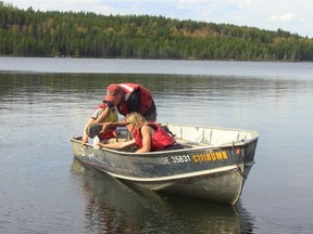 A field crew takes water samples in a Canadian lake. Canadian Press file photo