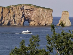 A sightseeing ship passes by the Perce rock, landmark of the Gaspé region Tuesday July 22, 2008 in Perce, Que.