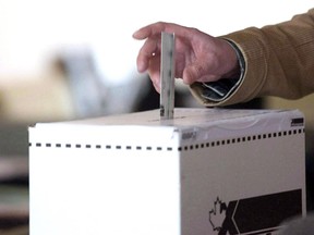 A voter casts a ballot in the 2011 federal election in Toronto on May 2, 2011.