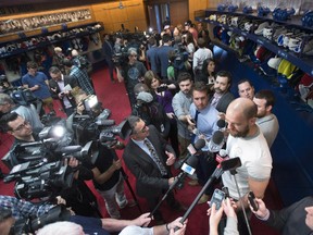Reporters gather around Canadiens defenceman Andrei Markov at the team's training facility in Brossard on May 14, 2015 after team was eliminated by the Tampa Bay Lightning in the playoffs.