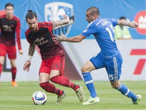 Montreal Impact's Andres Romero, right, challenges Portland Timbers' Liam Ridgewell during first half MLS soccer action in Montreal, Saturday, May 9, 2015.
