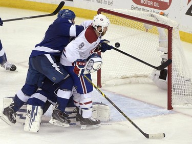 Montreal Canadiens right wing Brandon Prust (8) scores in front of Tampa Bay Lightning defenseman Jason Garrison (5) and goalie Andrei Vasilevskiy (obscured), of Russia, during the third period of Game 4 of a second-round NHL Stanley Cup hockey playoff series in Tampa, Fla., Thursday, May 7, 2015. The Canadiens won 6-2.