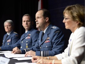 General Tom Lawson, second from right, Chief of the Defence Staff, speaks at a news conference in Ottawa on Thursday, April 30, 2015 following the release of an inquiry into sexual misconduct in the Canadian Forces. Marie Deschamps, a former Supreme Court justice and the report's author is at right, Maj.-Gen. Chris Whitecross is at left and Chief Warrant Officer Kevin West is second from left.