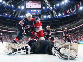 Goaltender Connor Hellebuyck of USA smothers the puck as Jakub Voracek of Czech Republic closes in during the 2015 IIHF Ice Hockey World Championship bronze medal game between Czech Republic and USA at the O2 Arena on May 17, 2015 in Prague, Czech Republic.