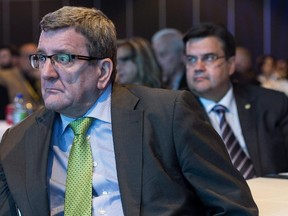 Quebec City mayor Régis Labeaume, left, and Montreal mayor Denis Coderre listen to proceedings at the Quebec Union of Municipalities annual convention Thursday, May 21, 2015, in Montreal.
