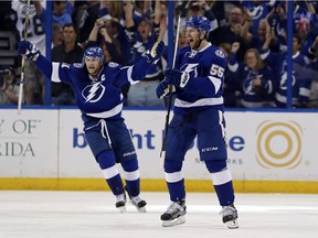 Braydon Coburn (No. 55) of the Tampa Bay Lightning celebrates his goal with teammate Steven Stamkos in Game Seven of the Eastern Conference quarter-finals against the Detroit Red Wings on April 29, 2015.
