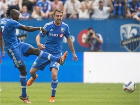 Montreal Impact's Dominic Oduro, left, scores on the Portland Timbers as Impact's Eric Alexander looks for the rebound during second half MLS soccer action in Montreal, Saturday, May 9, 2015.