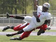 Chris Ackie of Wilfrid Laurier University tackles Melvin Abankwah of SMU at the East-West Bowl in 2014.