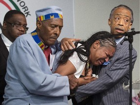 :Esaw Garner, widow of Eric Garner, who died as a result of a police chokehold, with reverends Herbert Daughtry and Al Sharpton (right), in July 2014. Nineteen crowdfunding sites were started in the wake of the New York man’s death.