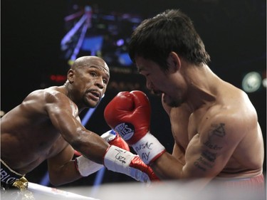 Floyd Mayweather Jr., left, trades blows with Manny Pacquiao, from the Philippines, during their welterweight title fight on Saturday, May 2, 2015 in Las Vegas.