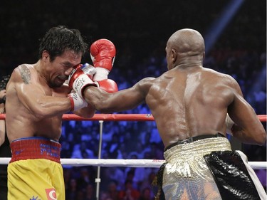 Floyd Mayweather Jr., right, hits Manny Pacquiao, from the Philippines, during their welterweight title fight on Saturday, May 2, 2015 in Las Vegas.