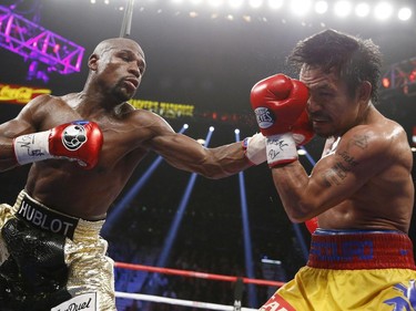 Floyd Mayweather Jr., left, lands a left to the head of Manny Pacquiao, from the Philippines, during their welterweight title fight on Saturday, May 2, 2015 in Las Vegas.