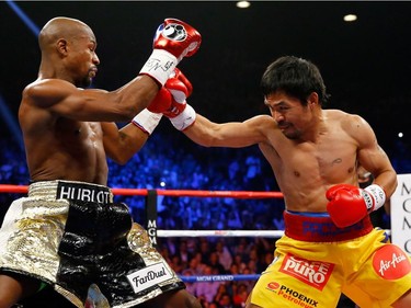 Manny Pacquiao throws a right at Floyd Mayweather Jr. during their welterweight unification championship bout on May 2, 2015 at MGM Grand Garden Arena in Las Vegas, Nevada.