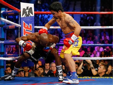 Manny Pacquiao throws a right at Floyd Mayweather Jr. during their welterweight unification championship bout on May 2, 2015 at MGM Grand Garden Arena in Las Vegas, Nevada.