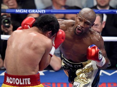 Floyd Mayweather Jr. throws a right at Manny Pacquiao during their welterweight unification championship bout on May 2, 2015 at MGM Grand Garden Arena in Las Vegas, Nevada.