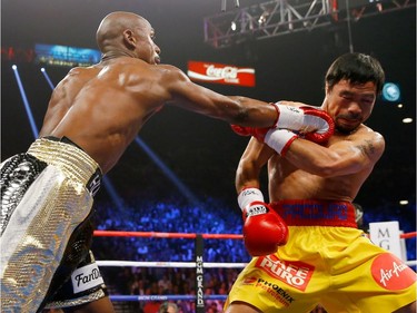 Floyd Mayweather Jr. throws a right at Manny Pacquiao during their welterweight unification championship bout on May 2, 2015 at MGM Grand Garden Arena in Las Vegas, Nevada.