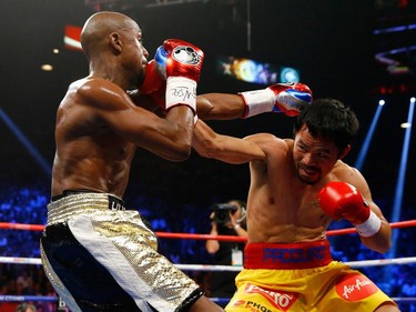 Floyd Mayweather Jr. and Manny Pacquiao exchange punches during their welterweight unification championship bout on May 2, 2015 at MGM Grand Garden Arena in Las Vegas, Nevada.