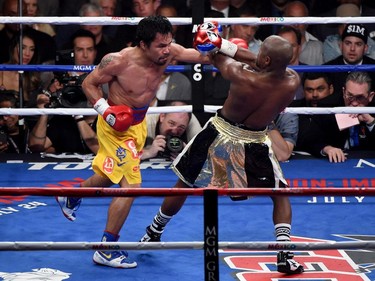 Manny Pacquiao throws a left at Floyd Mayweather Jr. during their welterweight unification championship bout on May 2, 2015 at MGM Grand Garden Arena in Las Vegas, Nevada.