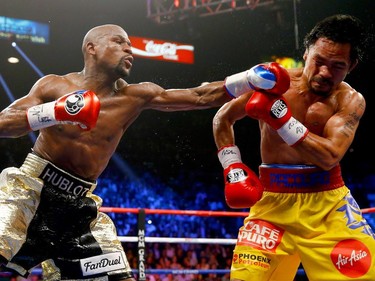 Floyd Mayweather Jr. throws a left at Manny Pacquiao during their welterweight unification championship bout on May 2, 2015 at MGM Grand Garden Arena in Las Vegas, Nevada.