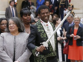 Haitian Canadian writer Dany Laferriére wearing his Academician suit and holding his Academician sword after his official entry ceremony as member of the Académie Française, which is an official authority on the French language.