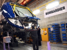 Employees work on the Bombardier Regio 2N double-deck train in 2013 in Crespin.