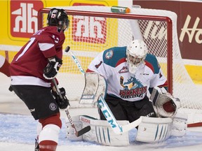 Kelowna Rockets goalie Jackson Whistle fails to stop a shot from Quebec Remparts' Nikolas Brouillard, not shown, as teammate Yanick Turcotte, left, watches the puck enter the net during first period action Friday, May 22, 2015 at the Memorial Cup tournament openning game in Quebec City.