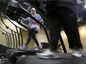 Gym members use as treadmill to warm up for a morning exercise class at Downsize Fitness in Addison, Tex., in 2013. Downsize Fitness was described as a selective gym where the rule is that new members must tip the scales. New members are weighed and have their body mass index measured.