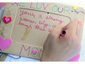 A child writes a note to her mother for Mother's Day.
