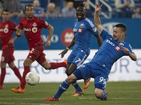 Montreal Impact forward Jack McInerney slips while shooting to the net while facing the Toronto FC during first half Amway Canadian soccer championship semifinal action Wednesday, May 6, 2015 in Montreal.
