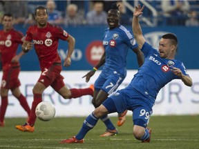 Impact forward Jack McInerney slips while shooting at the net against Toronto FC during first half of Amway Canadian Championship semifinal game on May 6, 2015 at Montreal's Saputo Stadium.