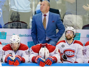 Montreal Canadiens head coach Michel Therrien, top, and players Lars Eller, left, Alex Galchenyuk, centre, and David Desharnais, right, react to the game-winning goal in the last second of play by Tampa Bay Lightning centre Tyler Johnson, not pictured, during the third period of game three of their NHL eastern conference semi-final hockey series at Amalie Arena in Tampa on Wednesday, May 6, 2015.