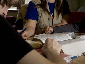 A counsellor helps two two students with home work at the Parc Ave. YMCA in Montreal Friday December 12 2008.